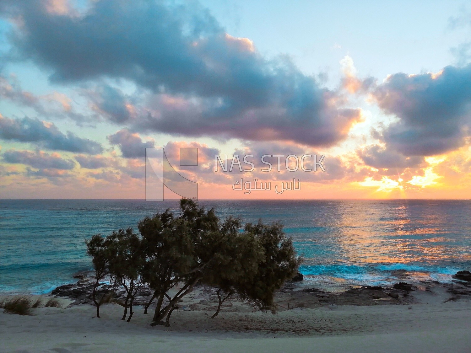 View of the white sand dunes and blue water in Marsa Matruh 