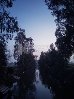 View of canal beside a village