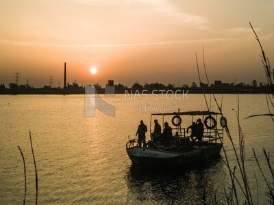 People on the boat in the river during the sunset