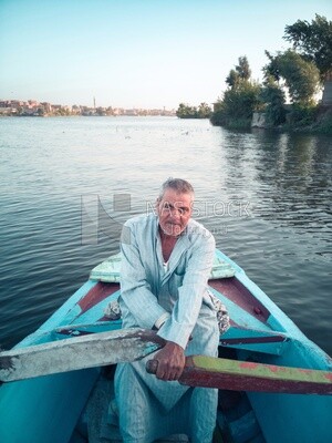 Man Rowing by an old boat