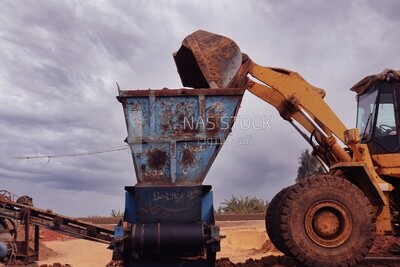 View of the tractor puts the sand in the machine to make bricks, brick industry