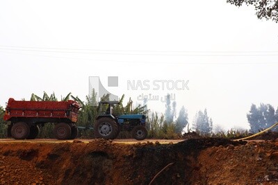 Tractor pulling a load of bricks, brick industry