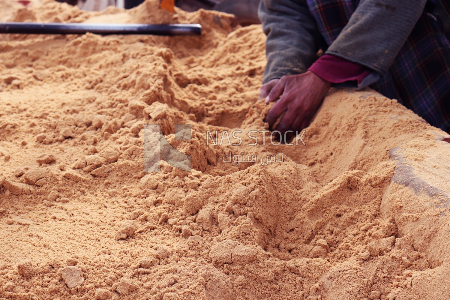 Man Puts his hand on the sand at the brick factory