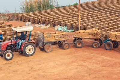Tractor pulling a load of bricks, brick industry