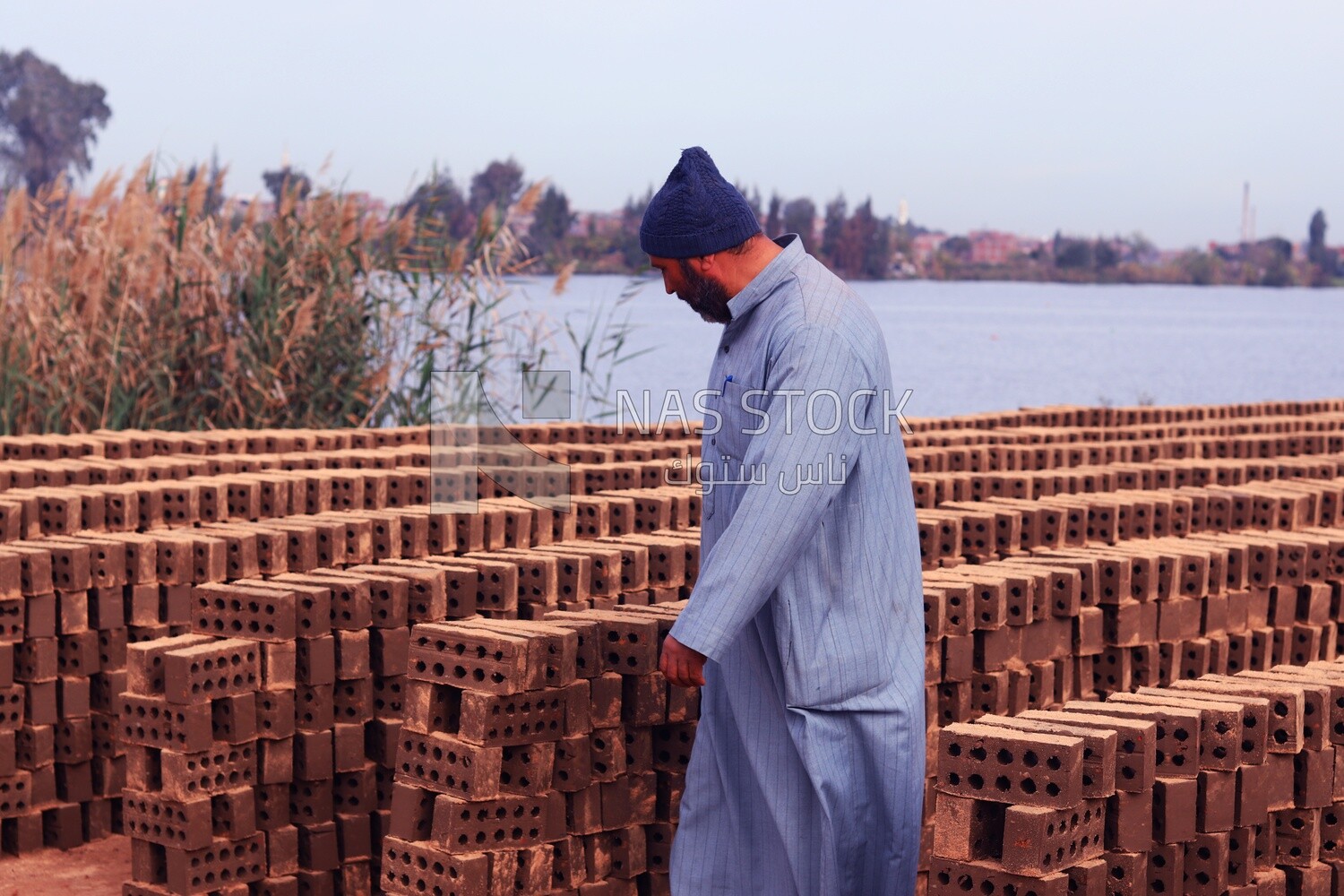 Man standing in front of the brick factory, brick industry