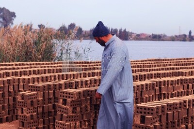 Man standing in front of the brick factory, brick industry