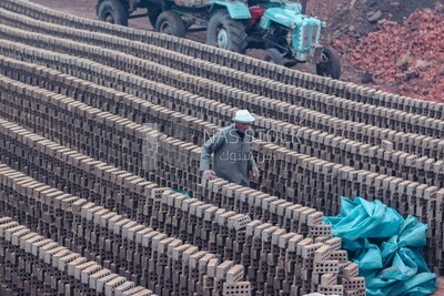 Worker walking in brick factory, brick industry