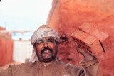 Worker holding bricks in brick factory, brick industry