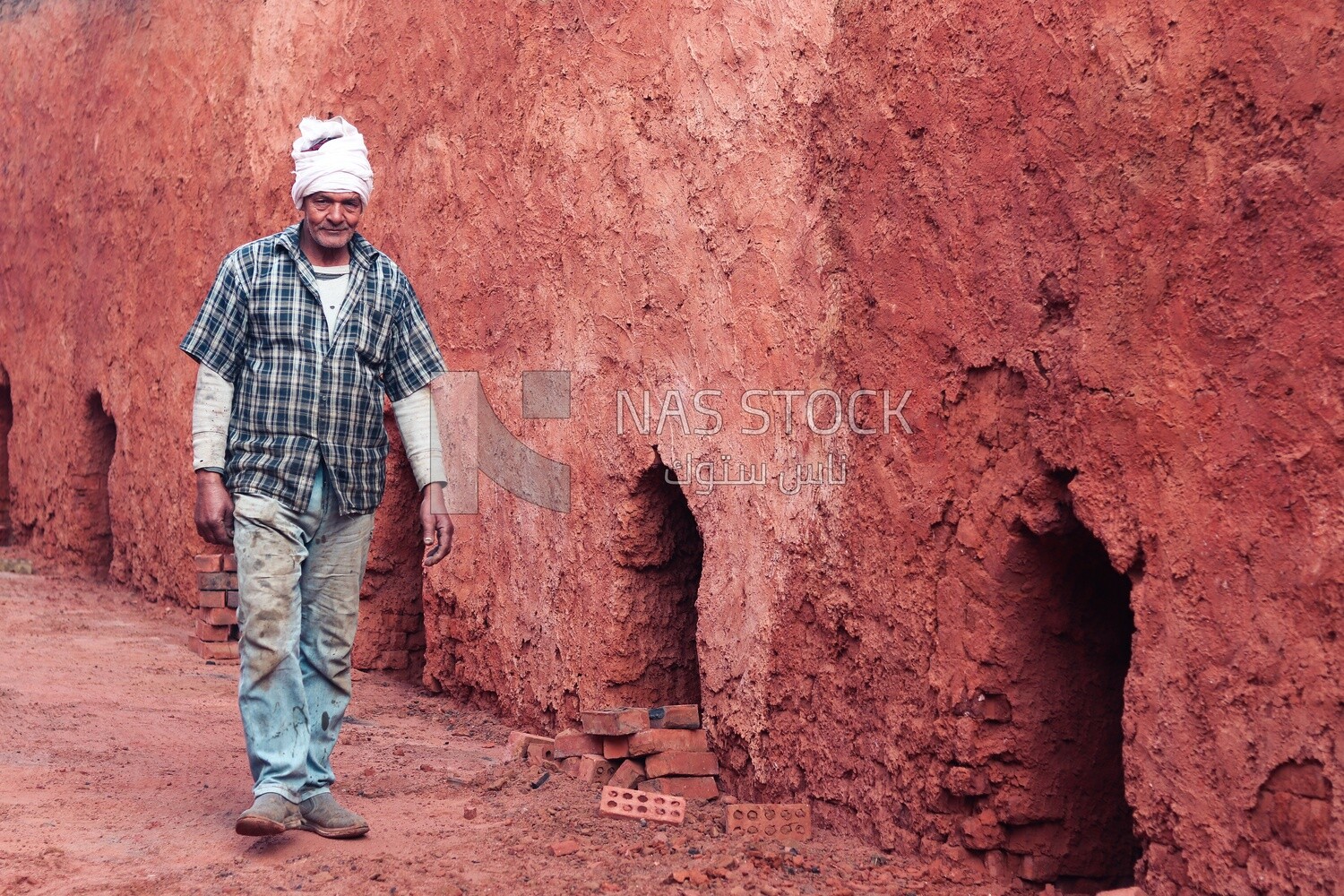 Worker walking in brick factory, brick industry