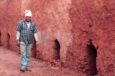 Worker walking in brick factory, brick industry