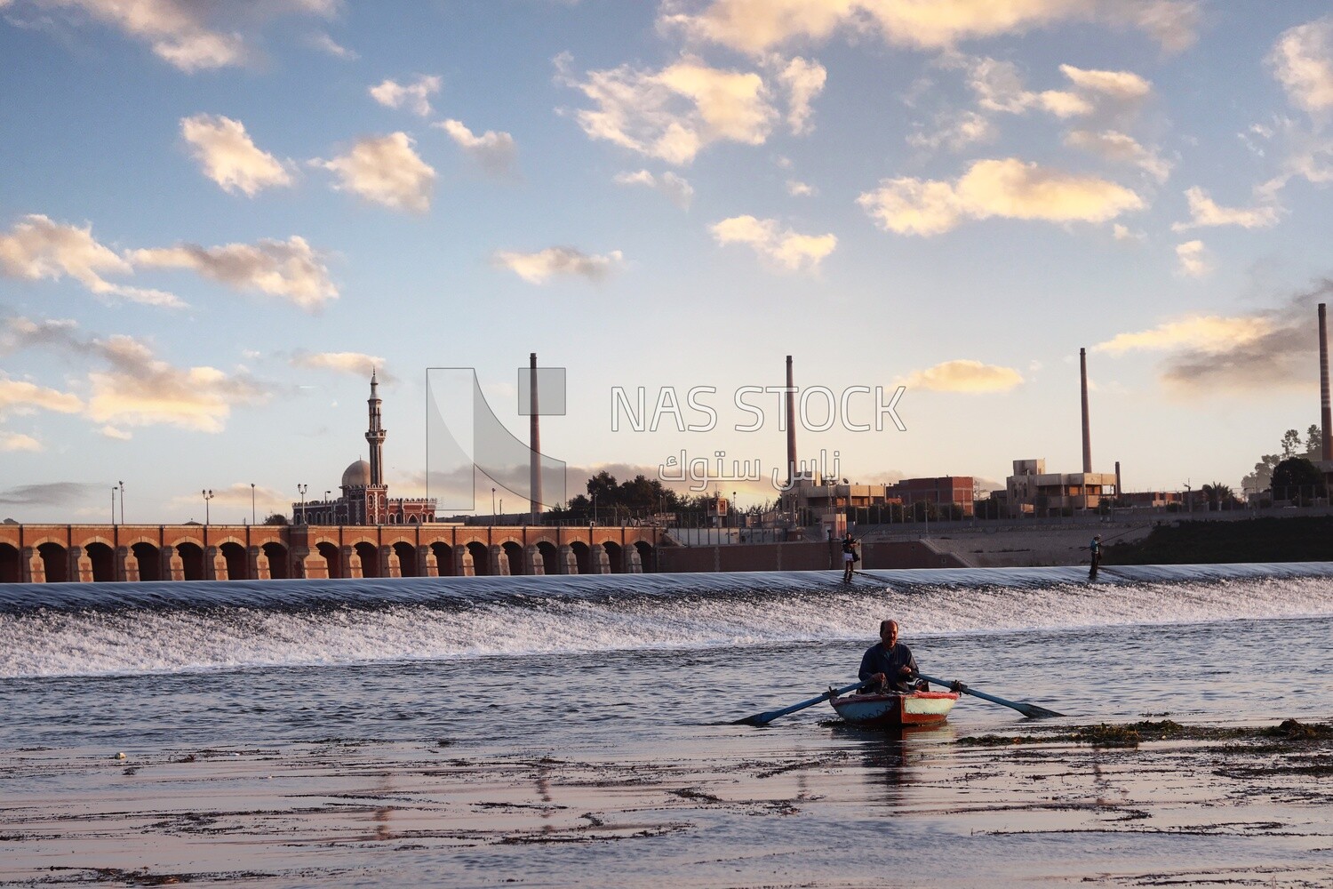 Man Rowing by an old boat