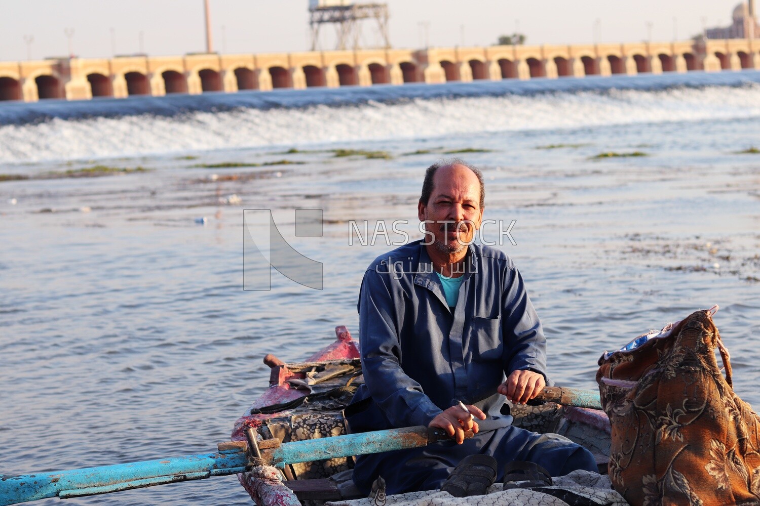 Man Rowing by an old boat