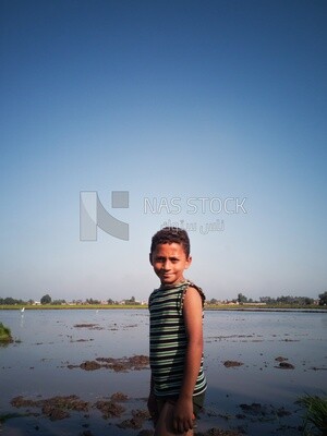 Boy standing in the field during the plowing of the land, Farm &amp; Agriculture, Cedar Nurseries