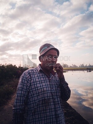 Close-up of a farmer smoking in the Cedar Nurseries, Farm &amp; Agriculture, Cedar Nurseries