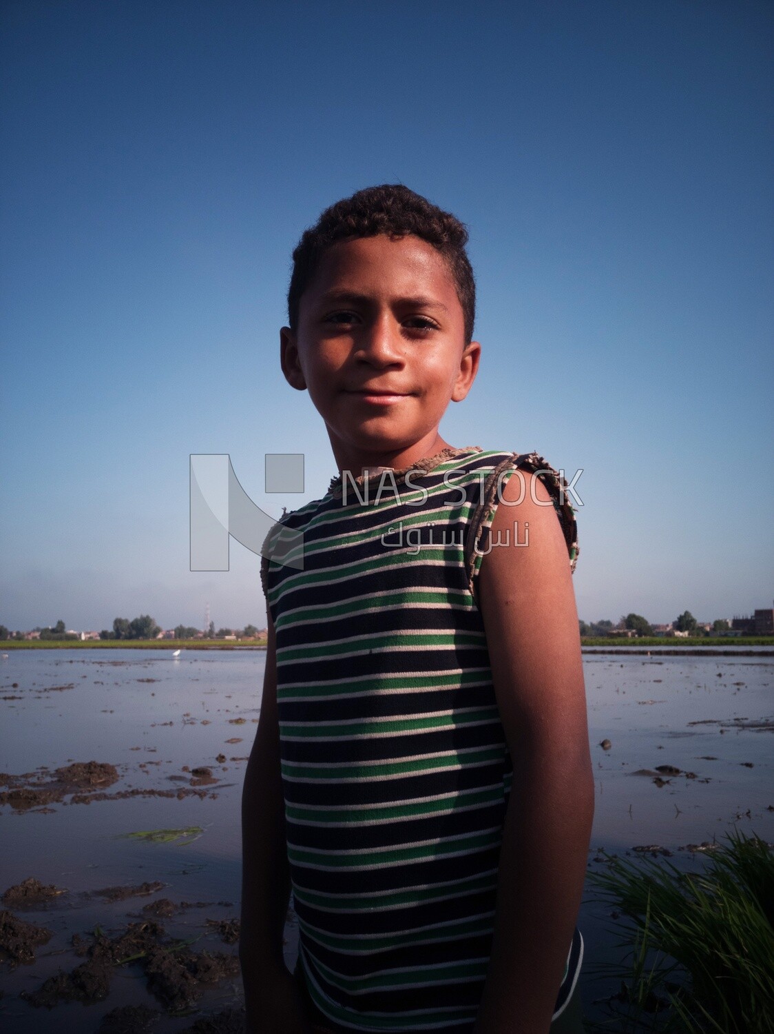 Boy standing in the field during the plowing of the land, Farm &amp; Agriculture, Cedar Nurseries