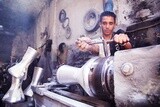 Man making an aluminum Drum in a workshop, the workshop services, music