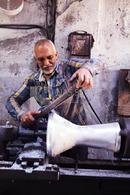 Man making an aluminum Drum in a workshop, the workshop services, music