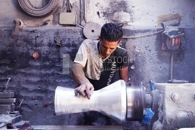 Man making an aluminum Drum in a workshop, the workshop services, music