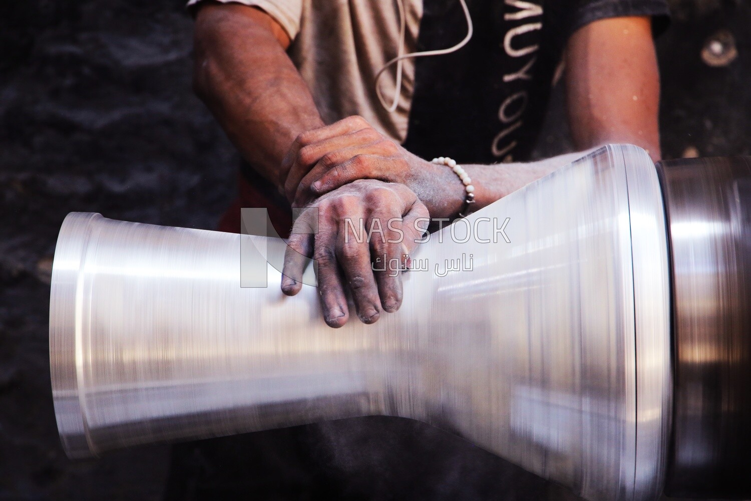 Man making an aluminum Drum in a workshop, the workshop services, music