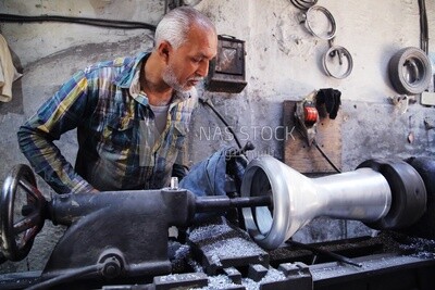 Man making an aluminum Drum in a workshop, the workshop services, music