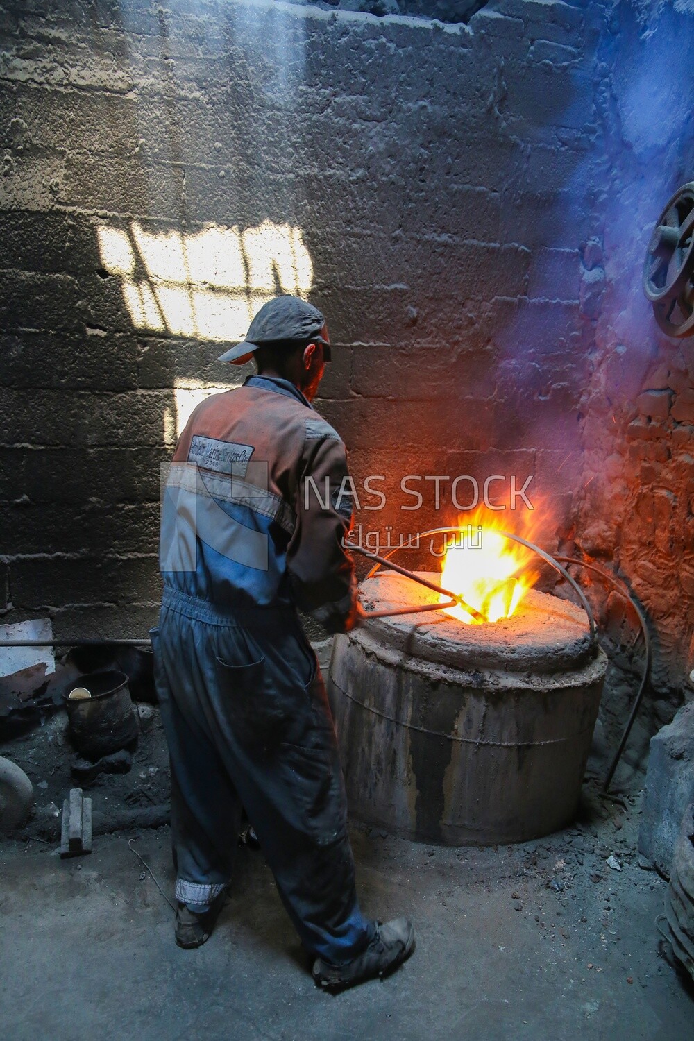 Blacksmith at work in his workshop by the fire, workshop, professional crafts