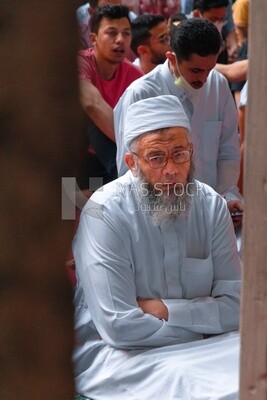 Man wearing white jilbab pray to the god