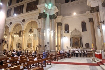 Church from the inside with a group of people praying
