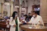 Man and his wife lighting candles inside the church