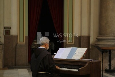 Pianist plays a hymn inside the church during holiday celebrations