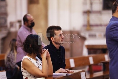 Husband with his wife sitting inside the church