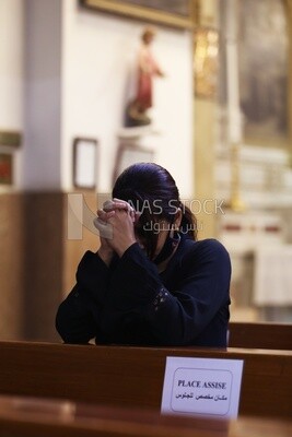 Woman praying inside a church