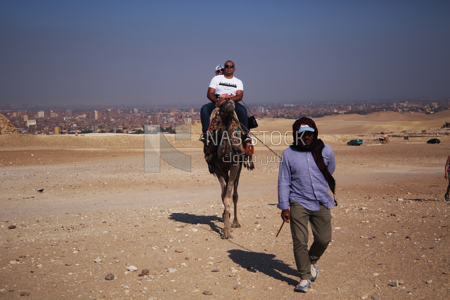 Tourists ride a camel