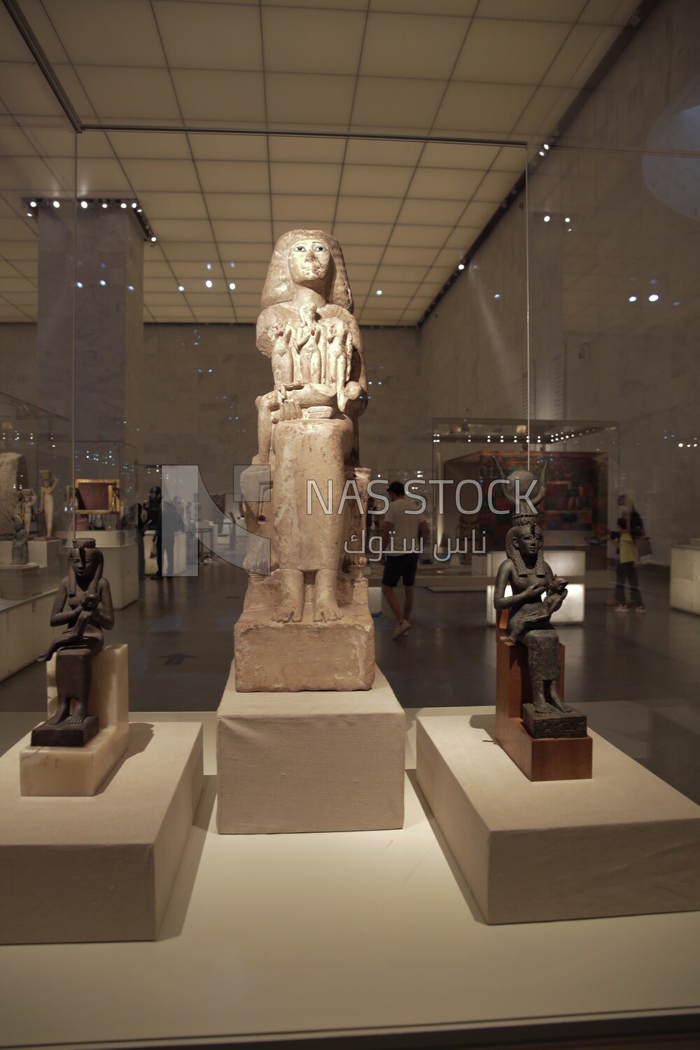 Antique statues are displayed in a glass box at the National Museum of Civilization, Cairo, Egypt.