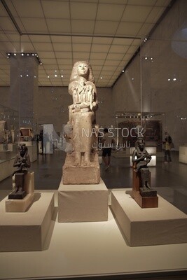 Antique statues are displayed in a glass box at the National Museum of Civilization, Cairo, Egypt.