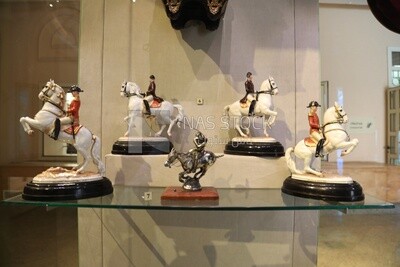 Group of statues displayed in a glass box inside the Royal Chariot Museum, Cairo, Egypt