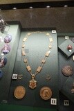 Group of royal collectibles and jewelry displayed in a glass box inside the Royal Chariots Museum, Cairo, Egypt