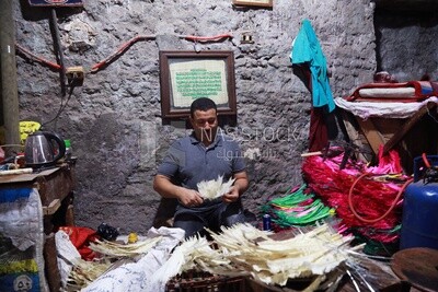 Man works in a feather workshop