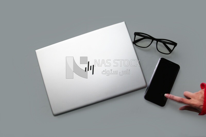 laptop with smartphone and glasses