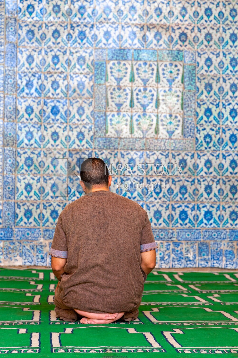 Man praying in The Aqsunqur Mosque, Tourism in Egypt, Famous landmarks in Egypt