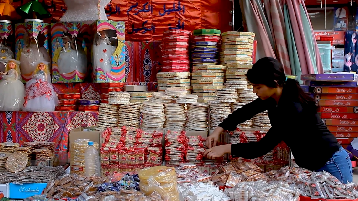 Girl standing and organizing the candies of Prophet Muhammad&#39;s Birth