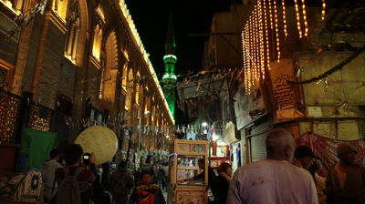 People on Al Moez Street at night, decoration lights