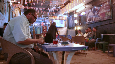 People sitting in a street coffee shop, Ramadan