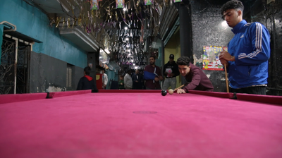 Boys playing billiards, street