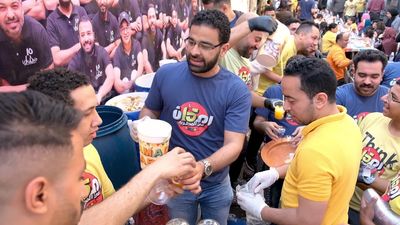 Men putting the juice in cups to share iftar, Ramadan Kareem, preparing their iftar