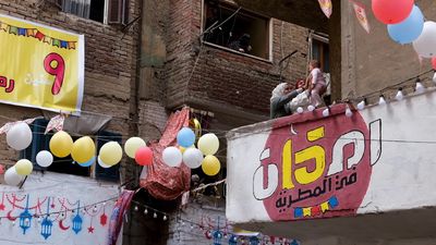 Women standing on the balcony watching the preparing of the iftar, Ramadan Kareem, preparing their iftar