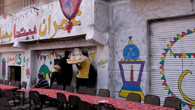 View of people in Matareya sharing their iftar together in the street, Ramadan Kareem, preparing their iftar