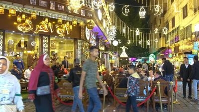 People sitting in a street coffee shop, Ramadan