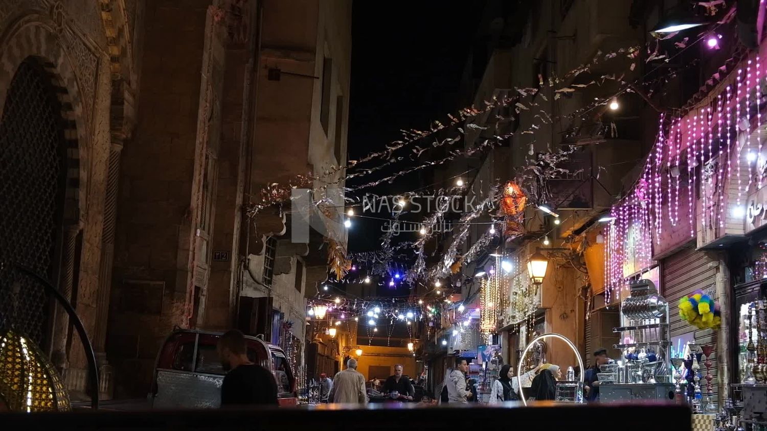 People on Al Moez Street at night, decoration lights