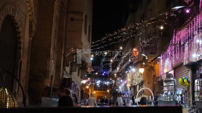 People on Al Moez Street at night, decoration lights