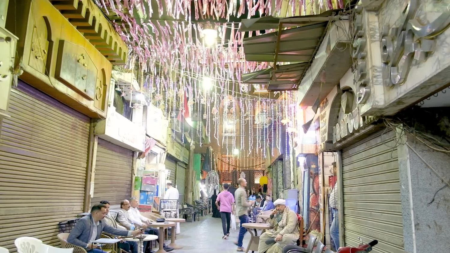 People sitting in a street coffee shop, Ramadan